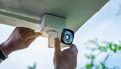 Technician installing residential security equipment